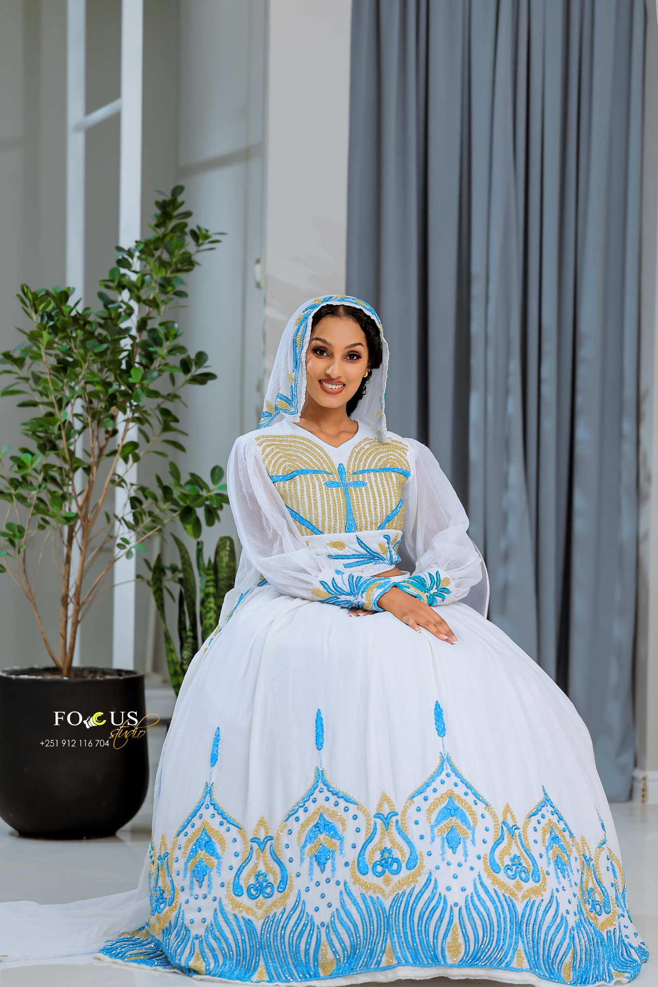 A bridal gown with blue and gold detailing